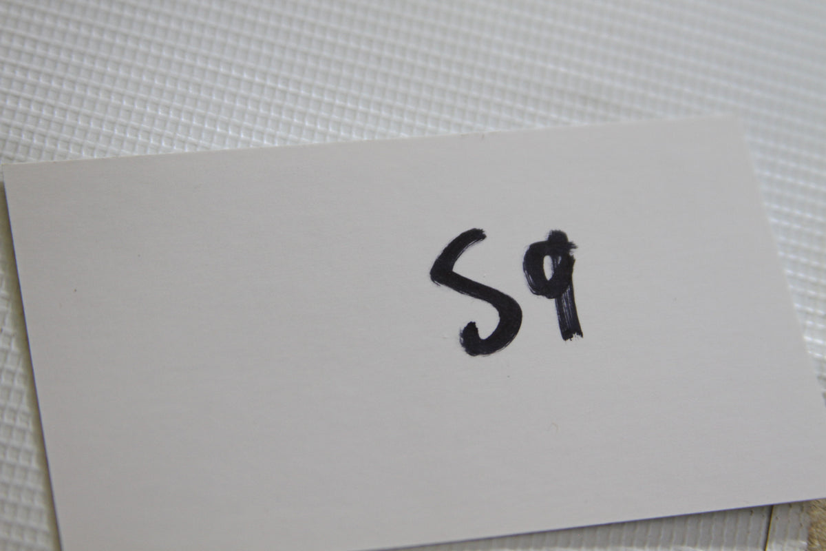 White card with handwritten 'S9'