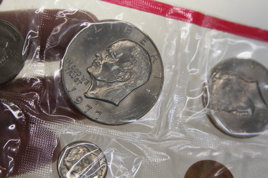 Close-up of Eisenhower dollar and other 1977 coins in original packaging