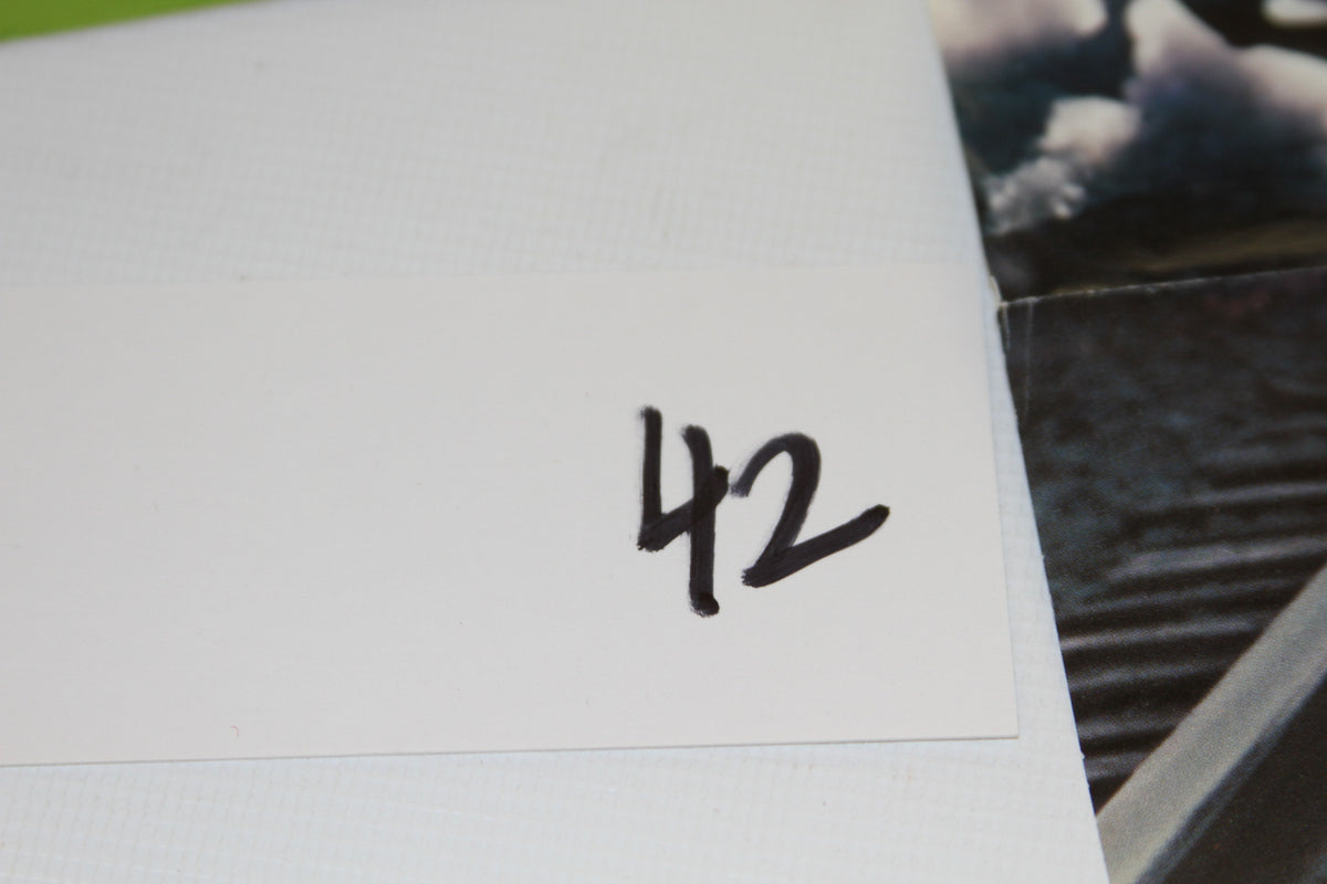 White card with the number 42 written in black marker