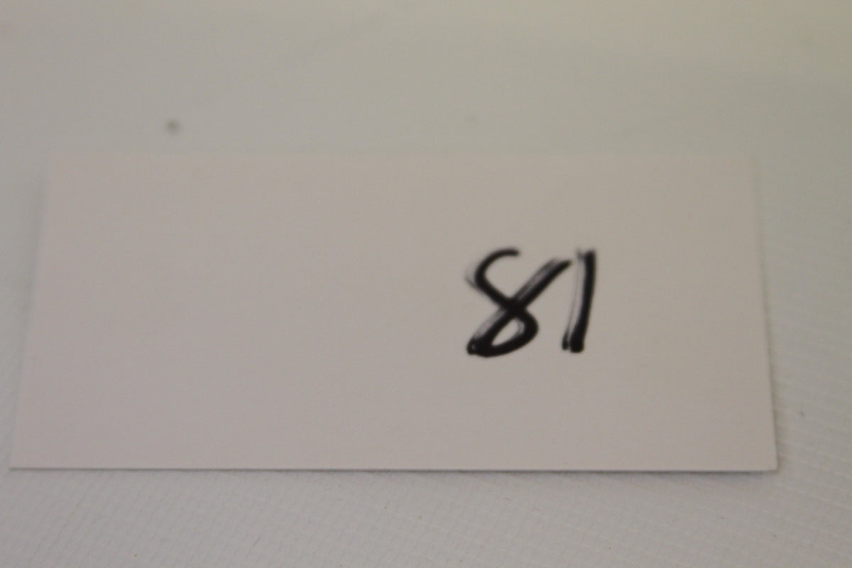 Index card labeled 81 near the coin set