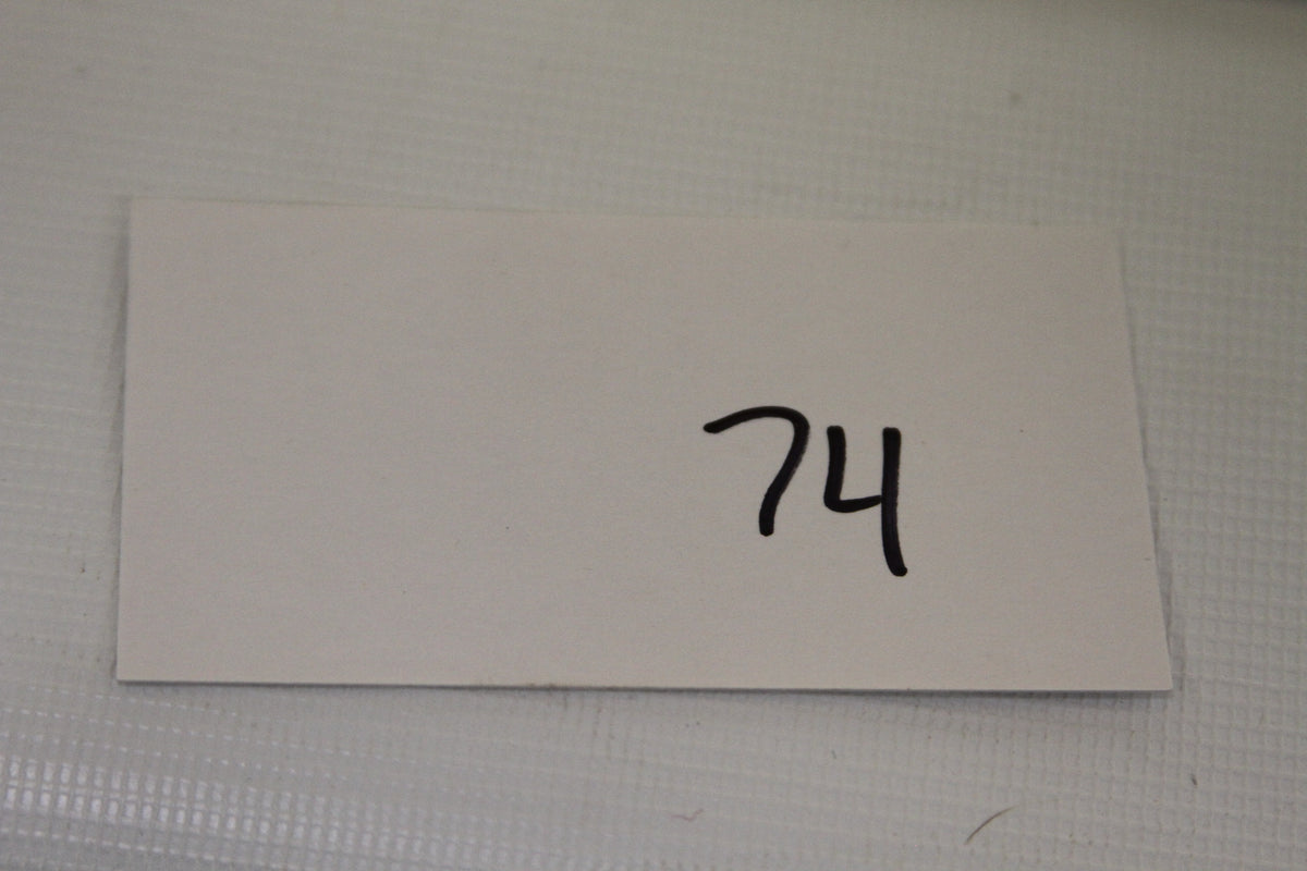 Card with number 74 written in black marker