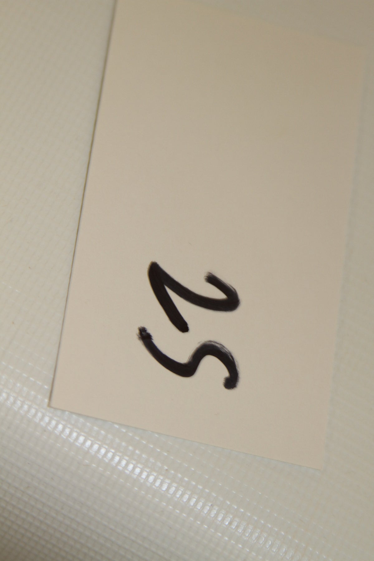 Closeup of handwritten card labeled 25