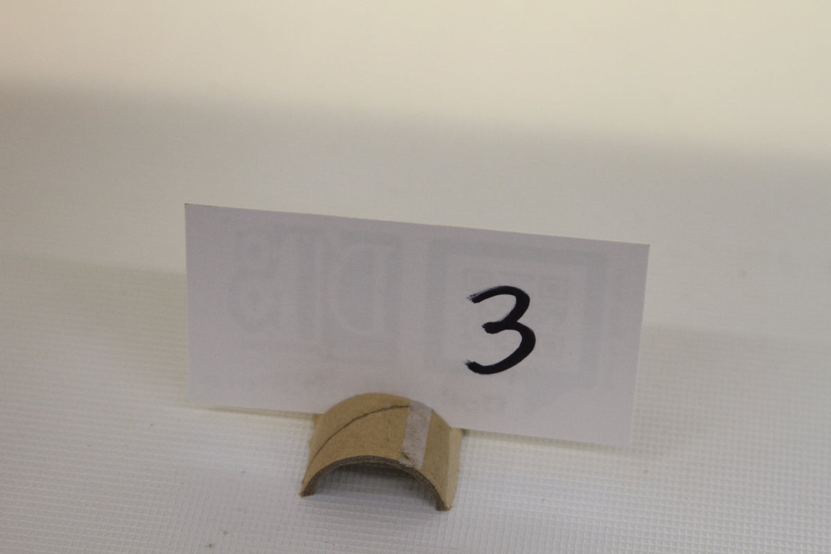 Cardboard stand with handwritten number 3