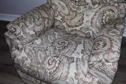Close-up of seat and armrest on paisley fabric recliner chair