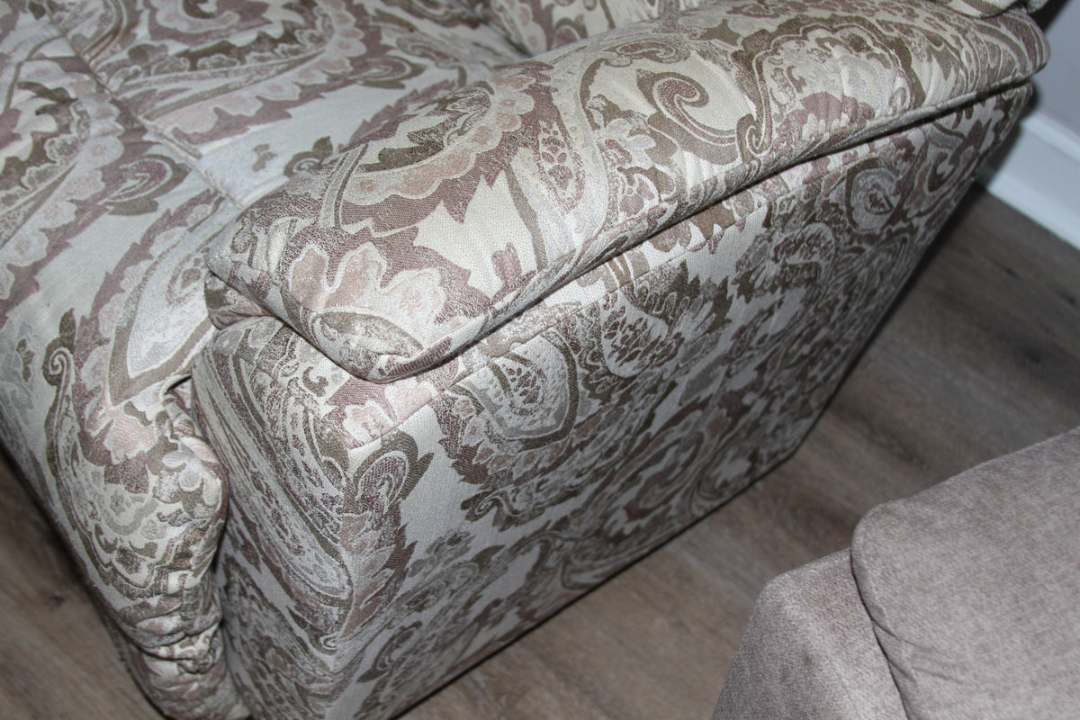 Armrest detail and side of paisley fabric recliner chair