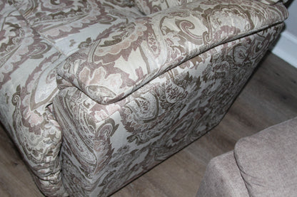 Armrest detail and side of paisley fabric recliner chair