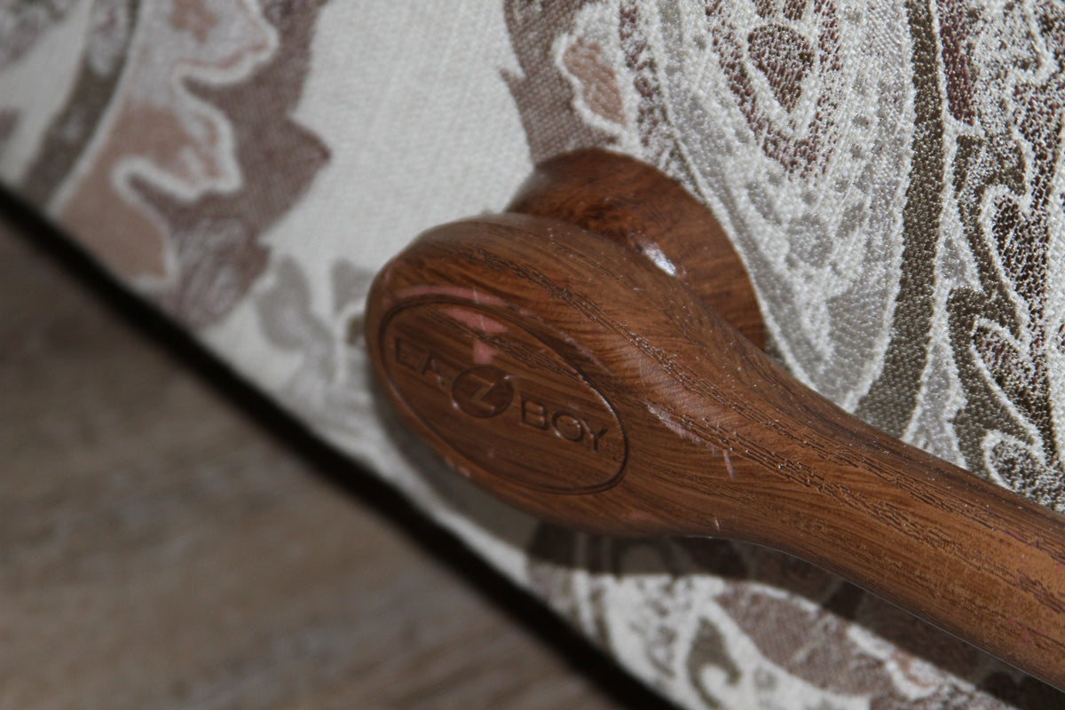Close-up of the La-Z-Boy branded wooden recline handle