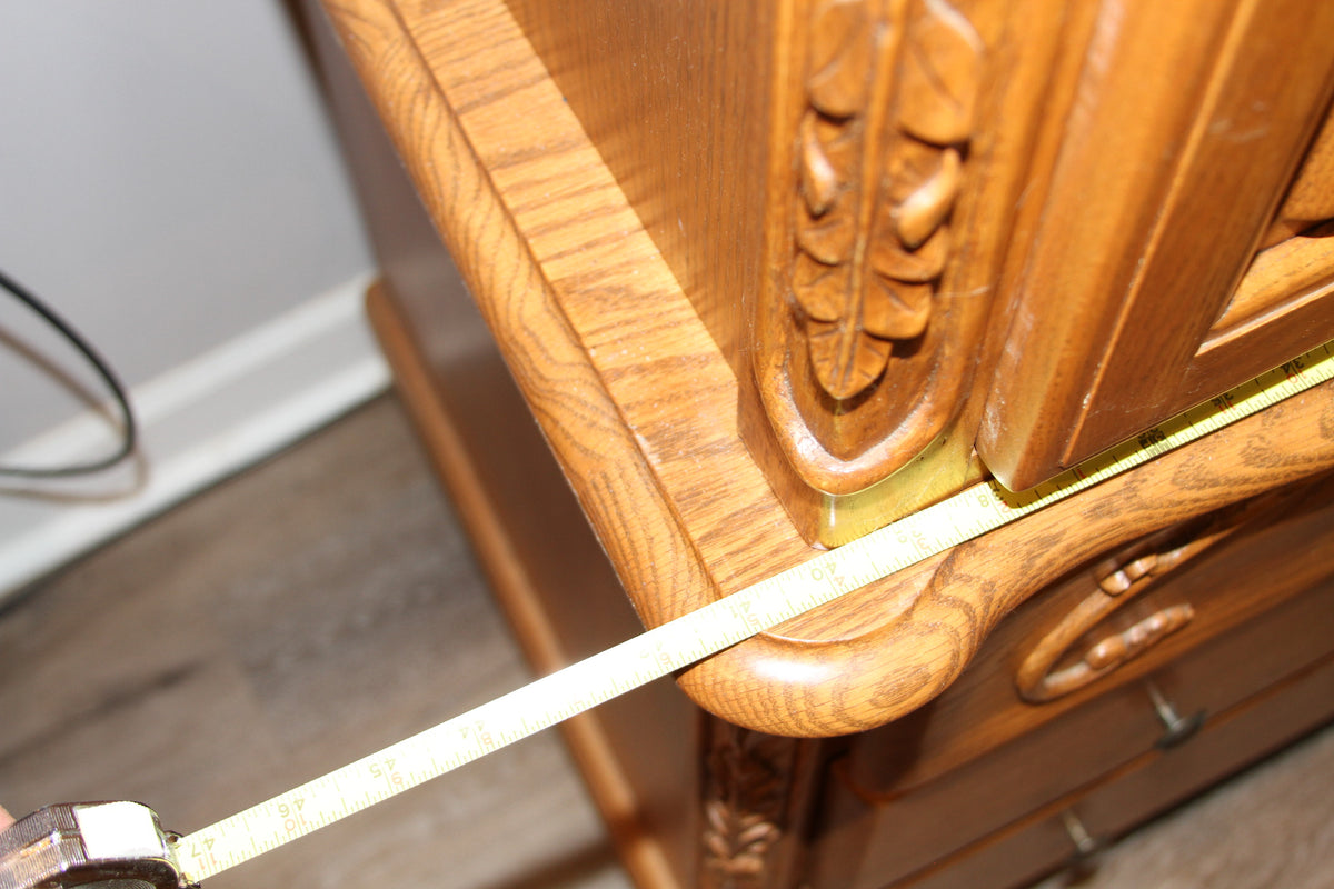 Measuring tape showing width detail on oak armoire top