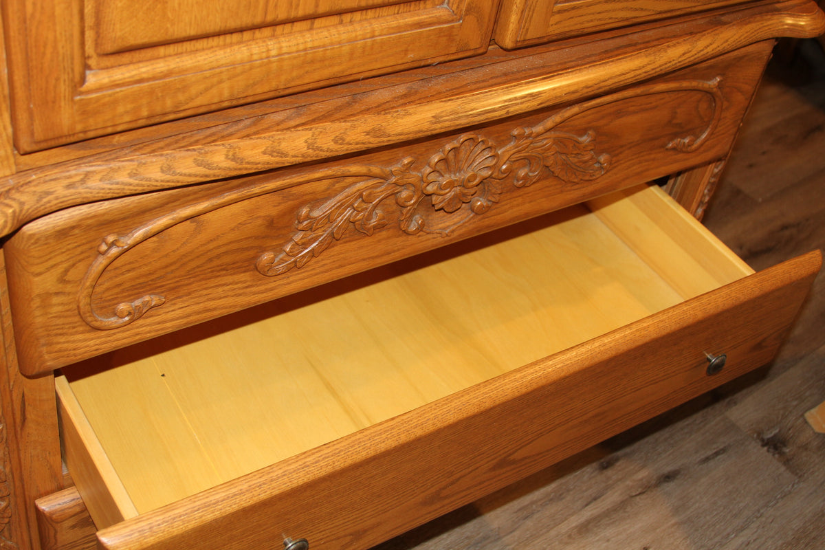 Open drawer showcasing spacious storage in oak wardrobe