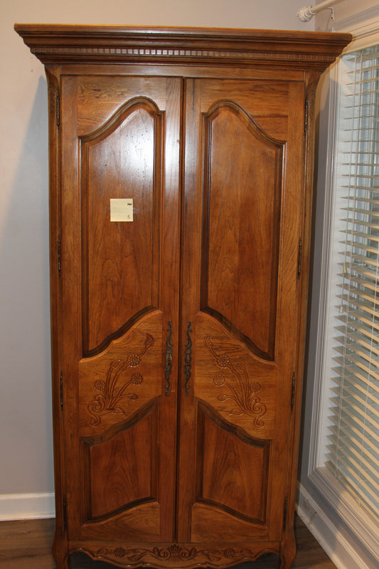 Full view of Bernhardt carved wood armoire with ornate floral doors