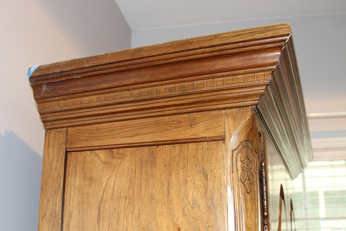 Detail of reeded cornice and wood grain on armoire top