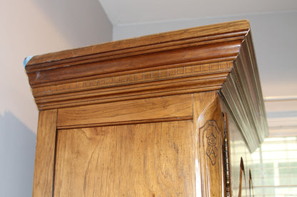 Detail of reeded cornice and wood grain on armoire top