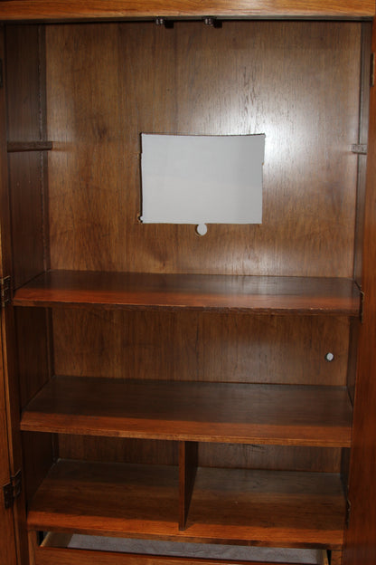Interior shelves and cable cutout of wooden armoire