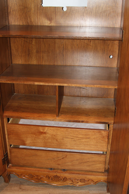 Lower shelves and open drawers inside armoire