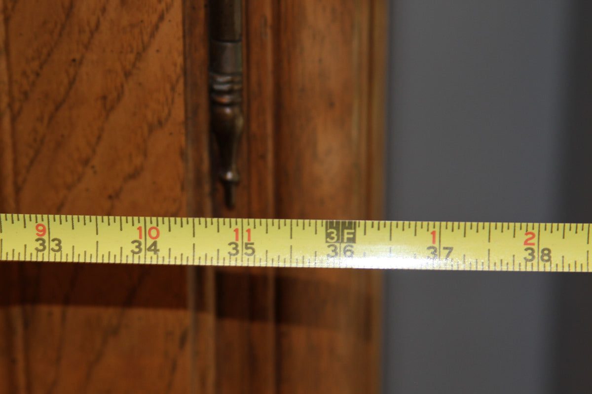 Measuring tape showing width of armoire at over 37 inches