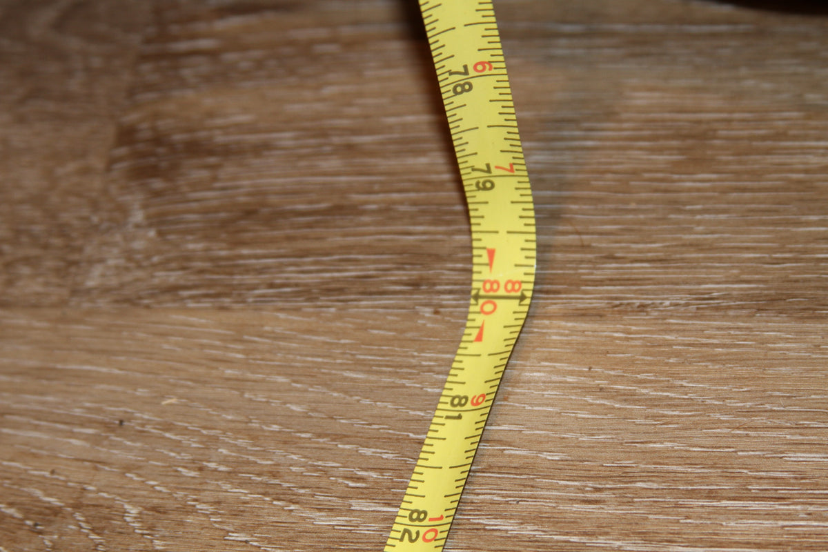 Measuring tape showing armoire height at 80 inches