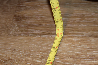 Measuring tape showing armoire height at 80 inches