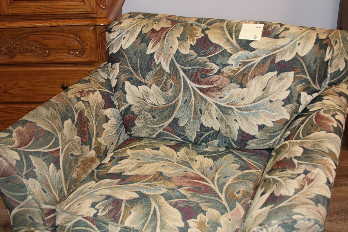 Close-up of club chair with leaf tapestry pattern