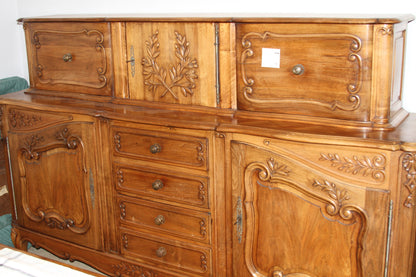 Hand-carved French Provincial buffet with hutch in warm walnut wood, ornate detailing, and antique brass hardware