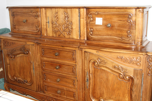 Hand-carved French Provincial buffet with hutch in warm walnut wood, ornate detailing, and antique brass hardware