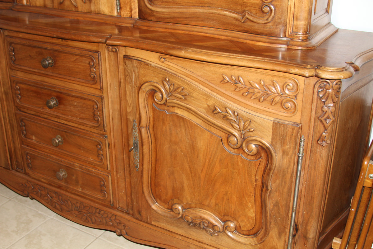 Close-up of buffet cabinet with carved flourishes and detailed brass hardware