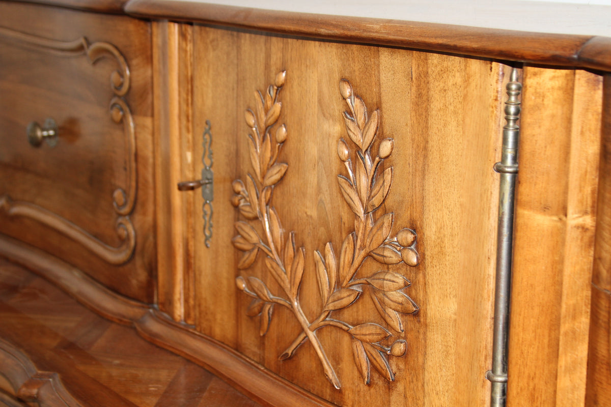 Close-up of carved olive branch motif on the upper hutch door of the buffet