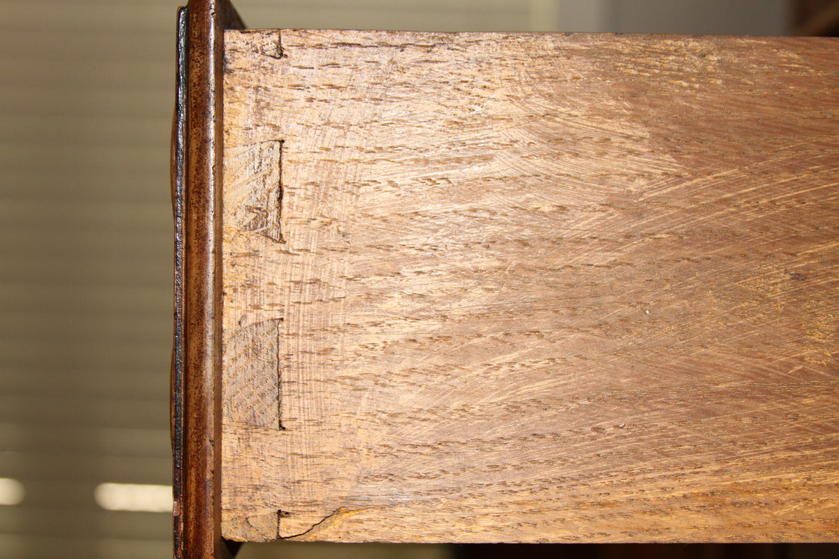 Dovetail construction close-up on drawer corner of carved walnut buffet