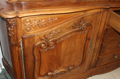 Detail of sideboard's carved panel and ornate hand-carved floral designs