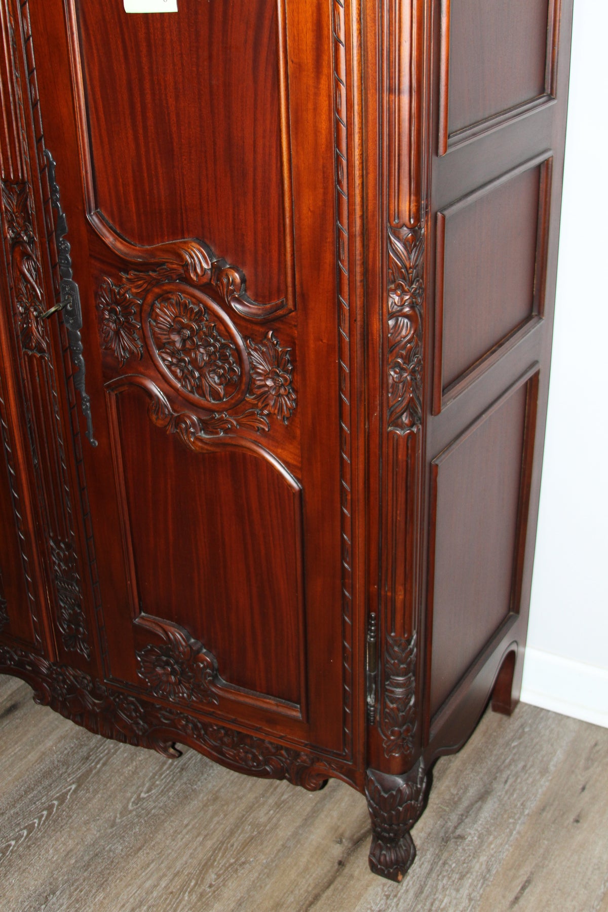 Lower section of armoire showing carved doors and bracket feet