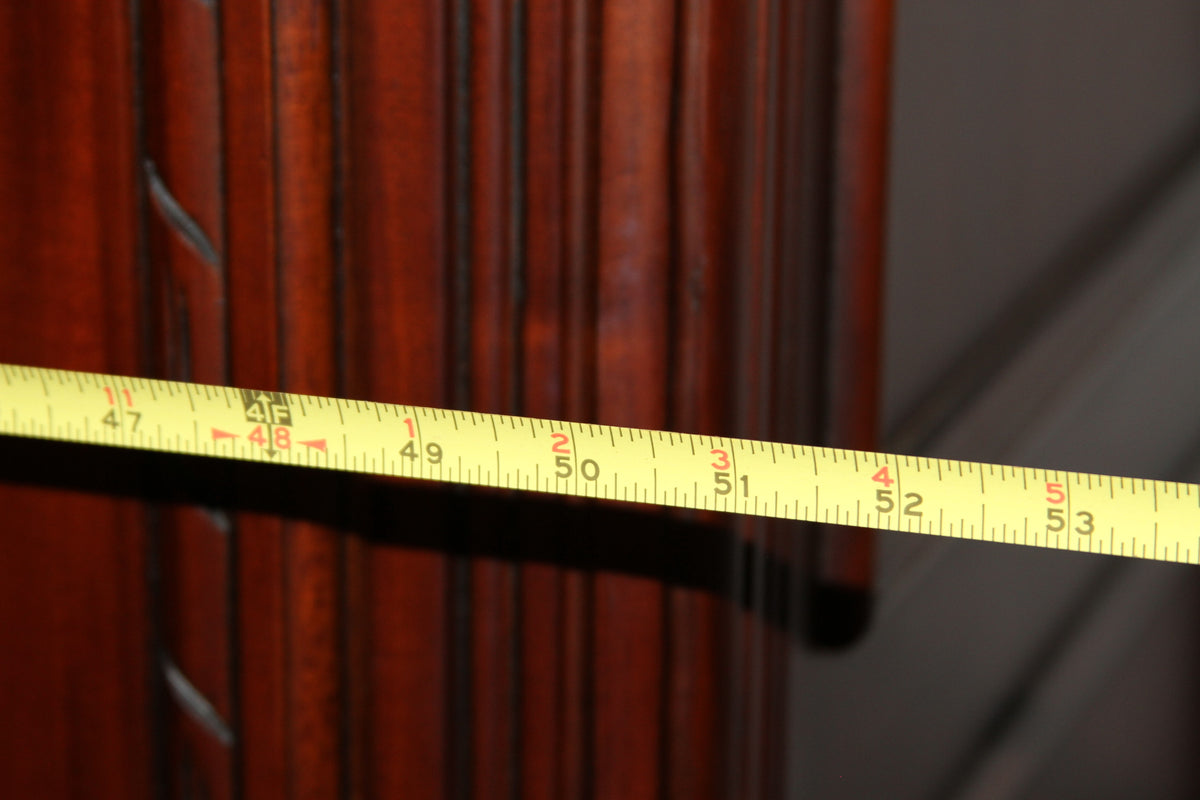 Tape measure across armoire showing width of about 52 inches