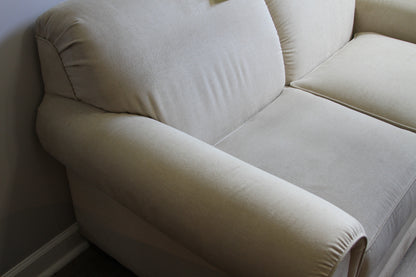 Close-up of left armrest and cushion on La-Z-Boy cream loveseat