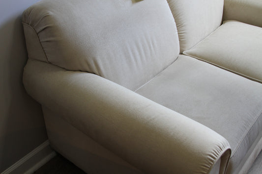 Close-up of left armrest and cushion on La-Z-Boy cream loveseat