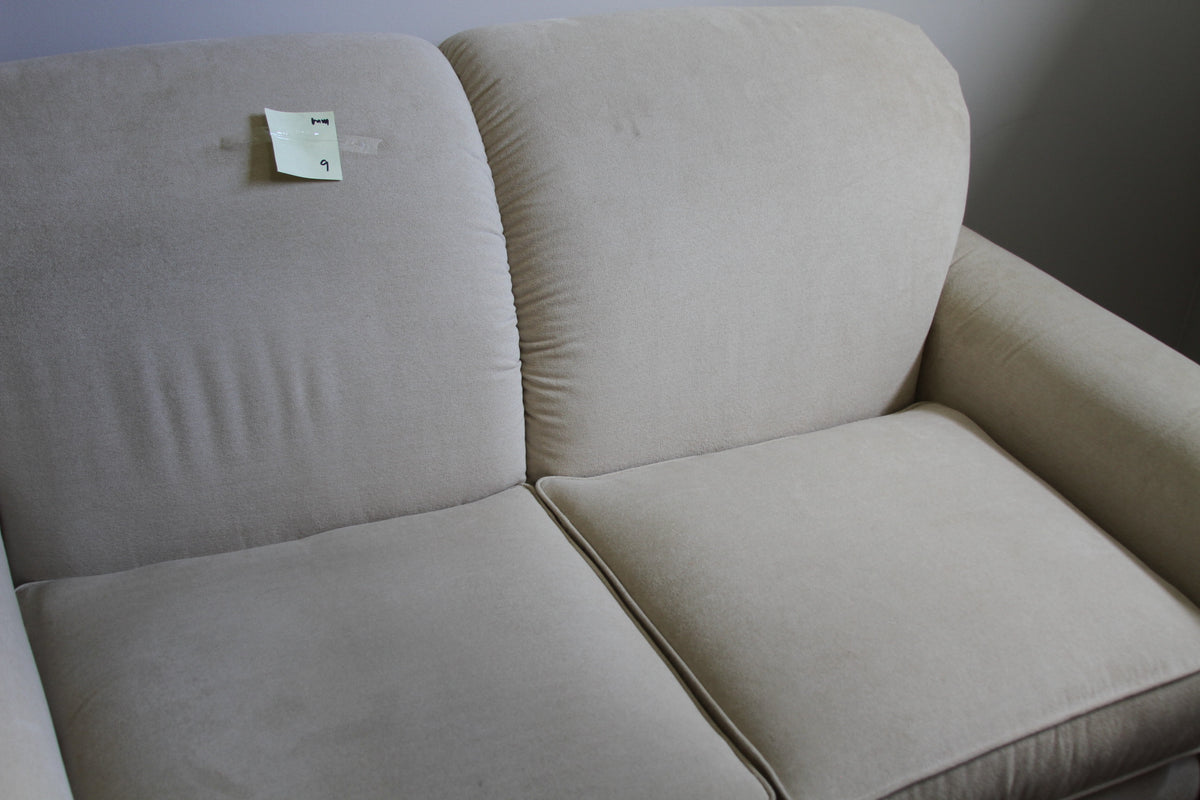 Detailed view of La-Z-Boy cream loveseat back and seat cushions