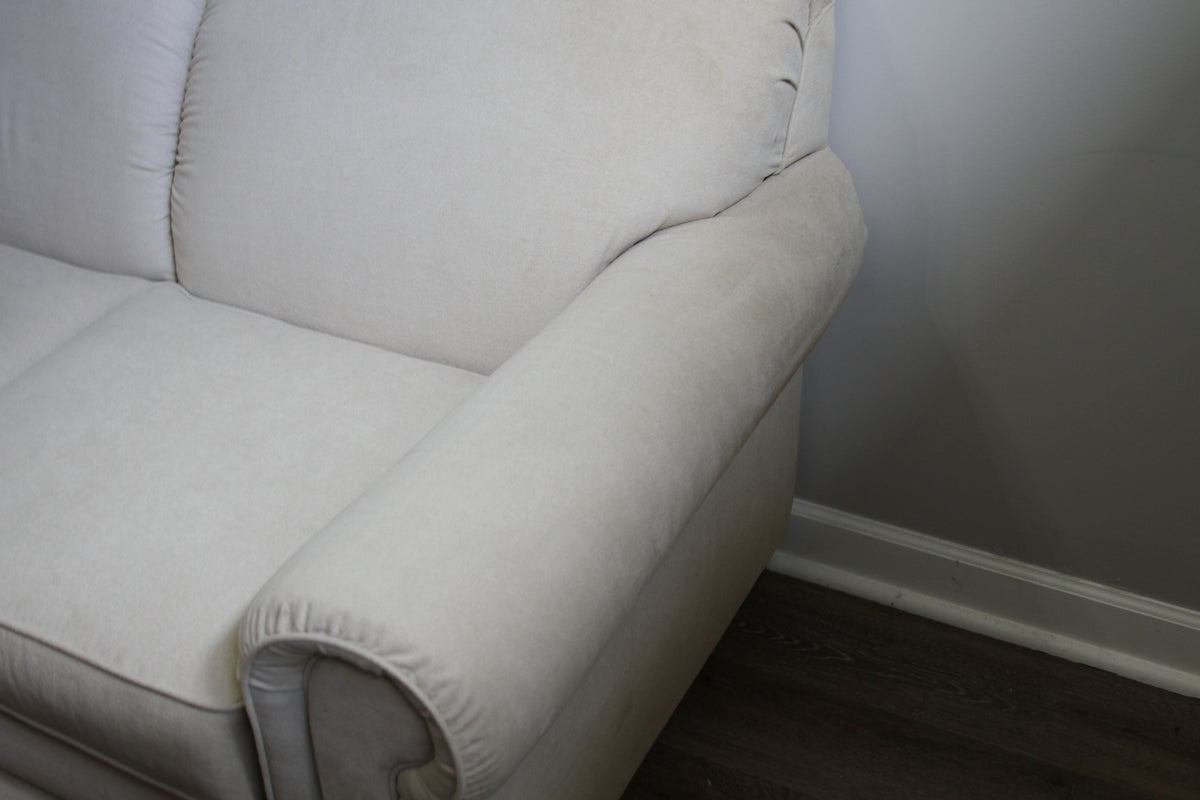 Close-up of right arm and cushion on La-Z-Boy cream loveseat