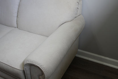 Close-up of right arm and cushion on La-Z-Boy cream loveseat