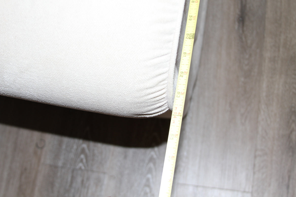 Measurement tape showing width of La-Z-Boy cream loveseat