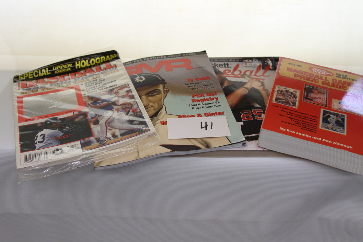 Various baseball card magazines and price guides laid out in a lot