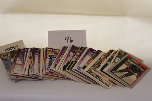 Assorted vintage NHL hockey trading cards spread out in a lot