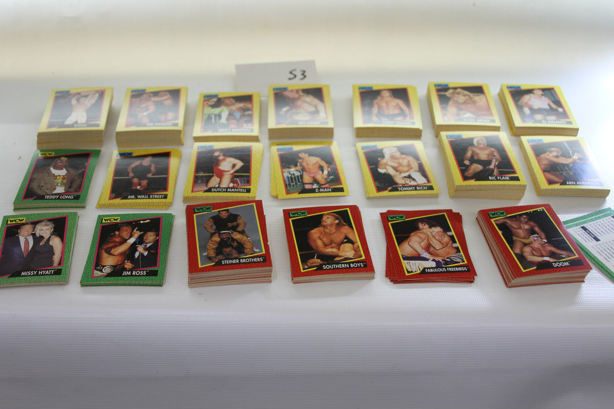 Stacks of 1991 WCW wrestling trading cards featuring famous wrestlers