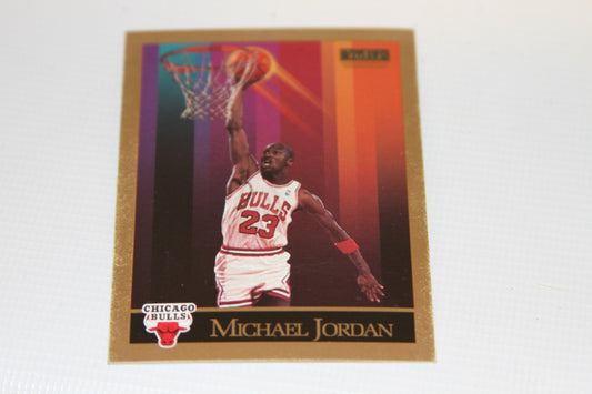 Front of 1990 SkyBox Michael Jordan basketball card showing Jordan dunking with gold border