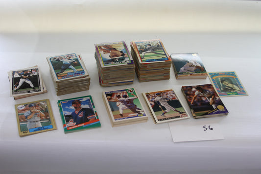 Assorted stacks of vintage baseball trading cards on white table