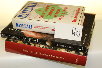 Stack of three baseball history hardcover books with a card labeled 40