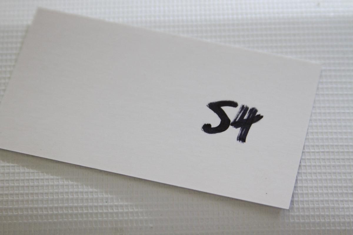 Blank white card with the handwritten number 54