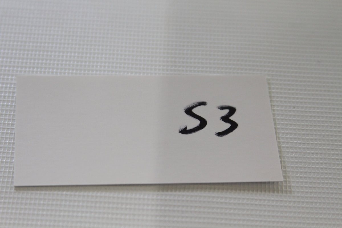 White S3 card label on table for trading card lot