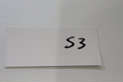 White S3 card label on table for trading card lot