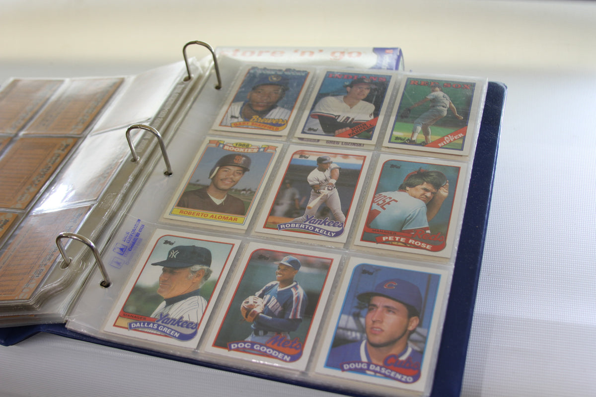 Binder page featuring Topps baseball cards including Roberto Alomar and Pete Rose