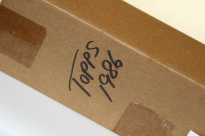 Close-up of 'Topps 1986' handwritten label on brown box