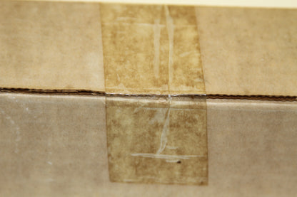 Close-up of sealed tape on brown cardboard box