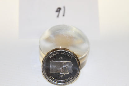 Front view of Pennsylvania Bicentennial commemorative coin with number 91