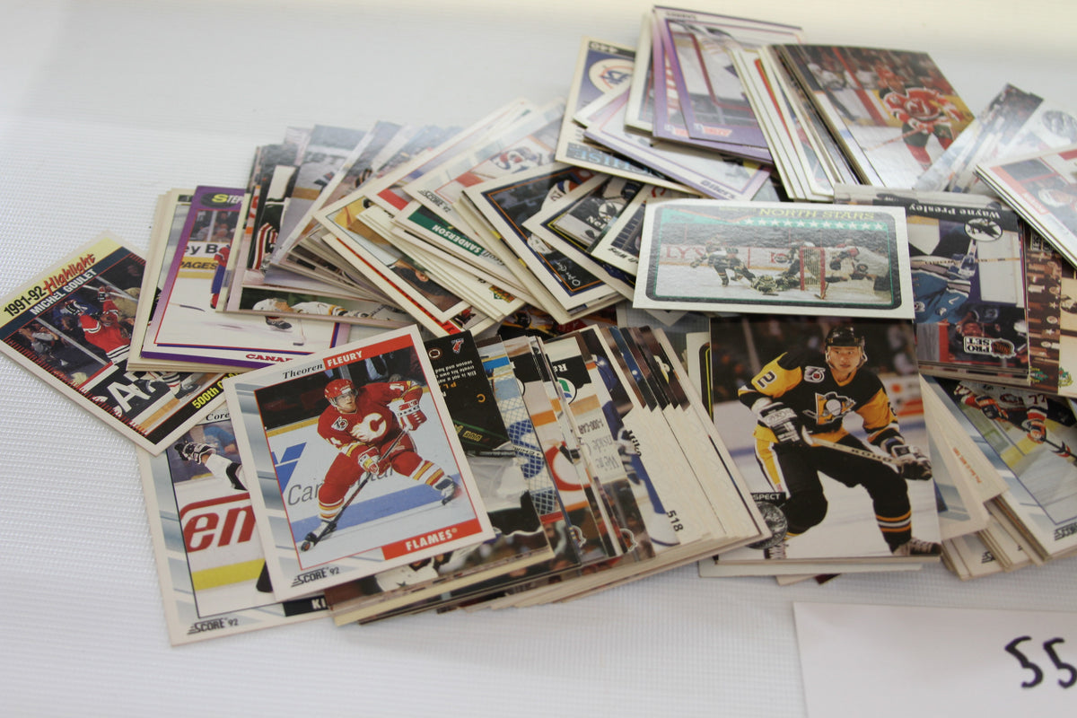 Close-up of assorted NHL hockey trading cards showing player photos and card designs.